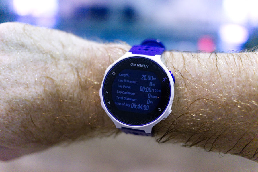 A Garmin 230 watch on a swimmer's arm