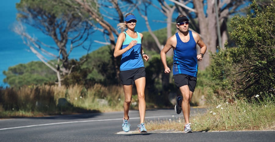 A female and a male running outdoors