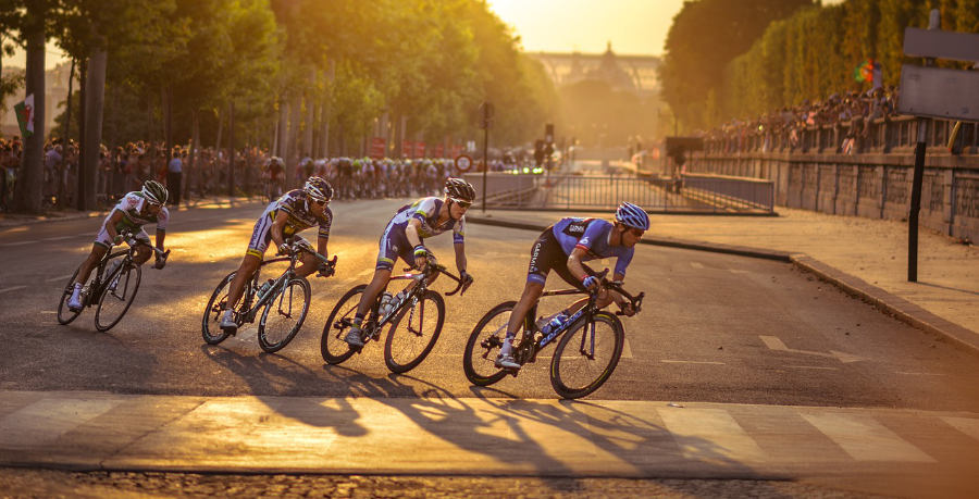 A photograph of a breakaway group of cyclists at a road bike race in a city