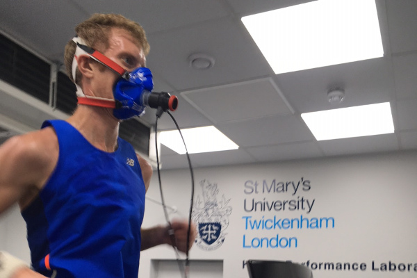 A photograph of a male runner taking a V02 test in a sports lab