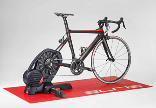 A photograph of a red Elite Cycling Trainer Mat with a road bike attached to an Elite Direto smart cycling trainer