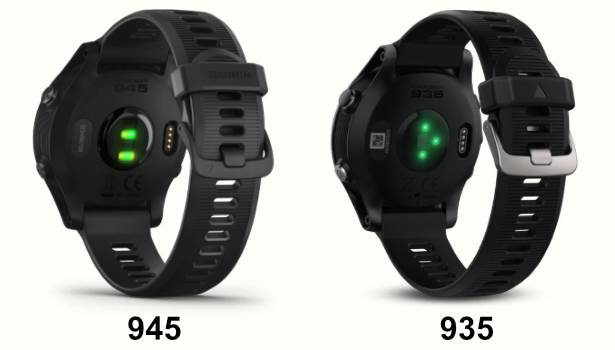A photo comparing the back of the Garmin Forerunner 945 and 935 triathlon watches