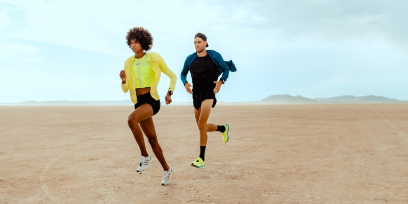 A male runner drafts behind a female runner using a Stryd running power meter