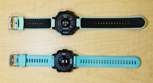 A photo of the backs of the Garmin Forerunner 245 and 235 running watches