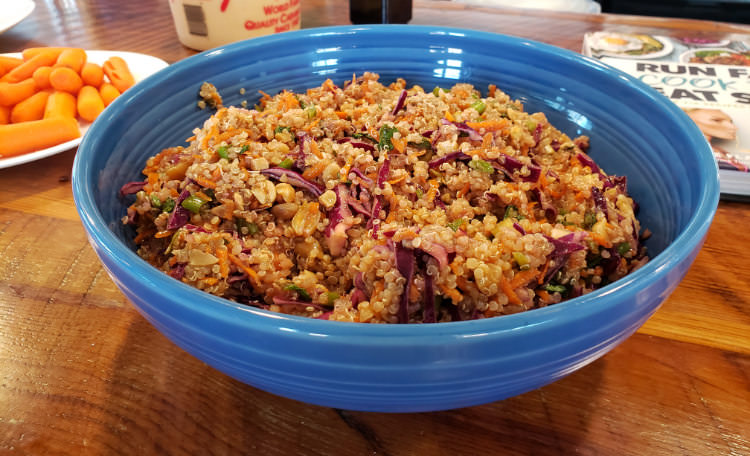 A blue ceramic bowl filled with Thai Quinoa salad