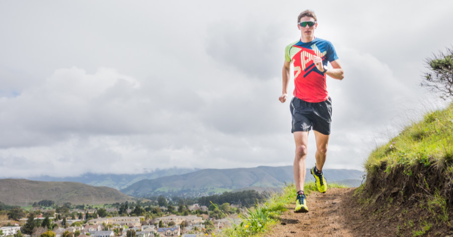 A photograph of Coach Ian Hosek on an endurance trail run at elevation